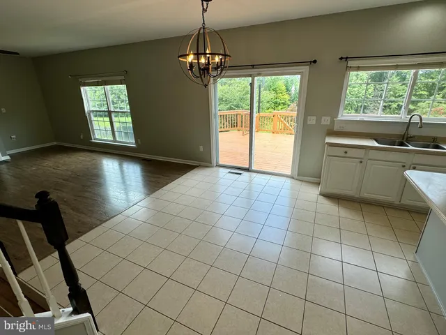 a view of an empty room with window and cabinet