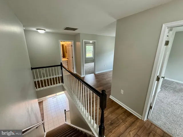 a view of an entryway with wooden floor