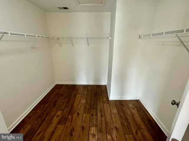 a view of a room with wooden floor and white walls