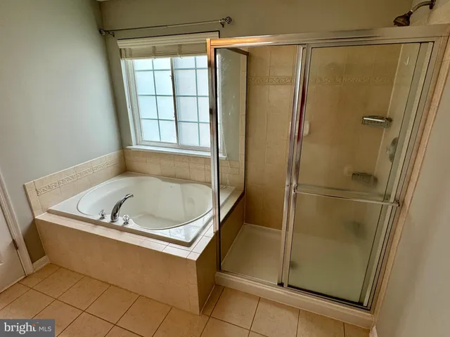 a bath tub sitting next to a shower