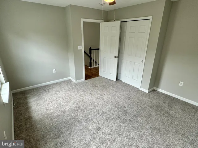 an empty room with closet and a bathroom