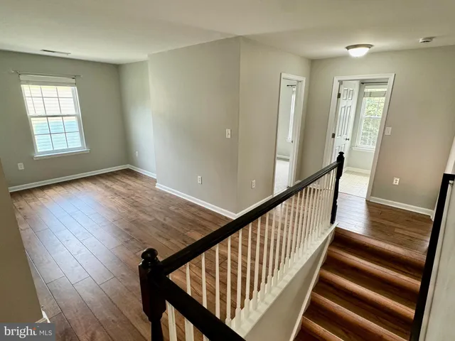 a view of an entryway with wooden floor