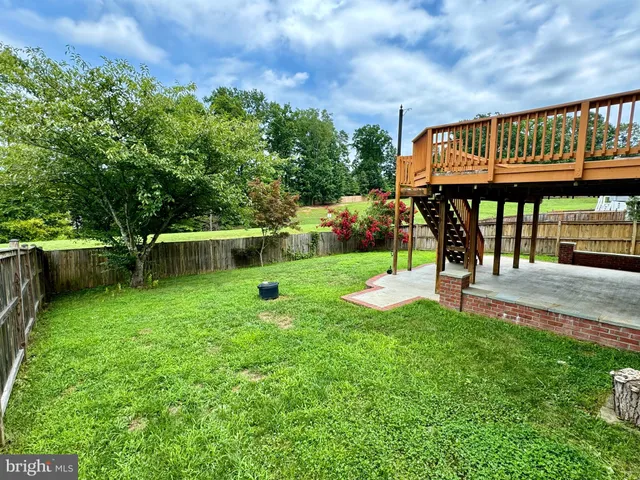 a view of a backyard with sitting area