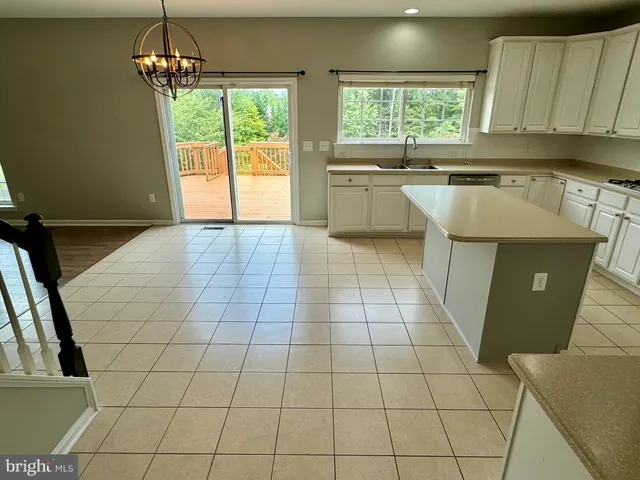 a kitchen with a sink a counter top space and cabinetry