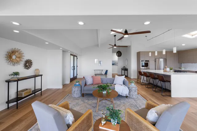 a living room with furniture and kitchen view