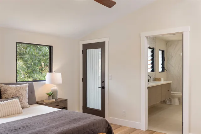 a bedroom with a bed and a large window