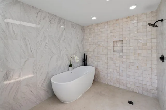 a bathroom with a bathtub and shower