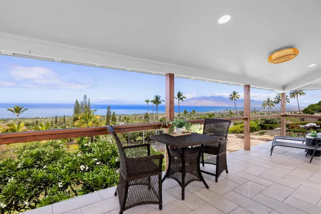 a view of a dining room with furniture a chandelier and wooden floor