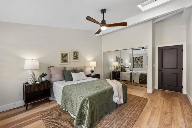 a bed room with a bed and a chandelier