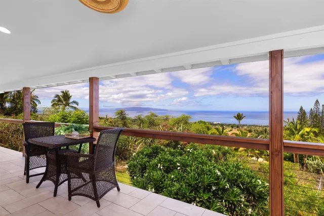 a view of a chairs and table in the balcony