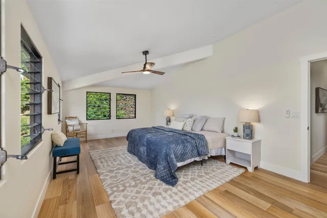 a bedroom with a large bed couch and a window