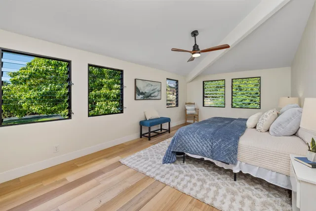 a bedroom with a large bed and a window