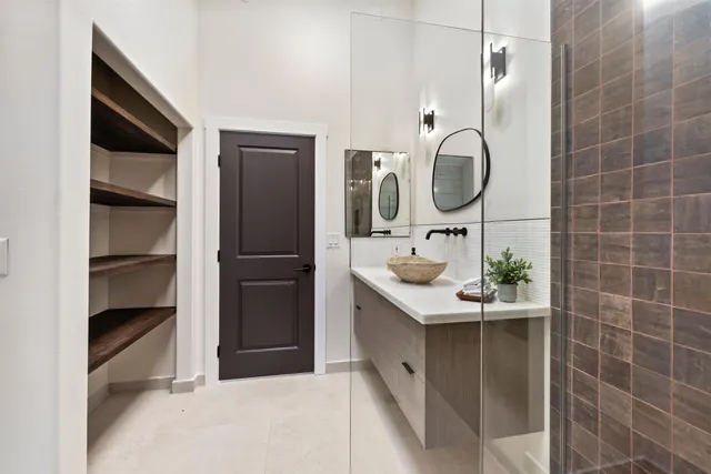 a bathroom with a sink a toilet and shower