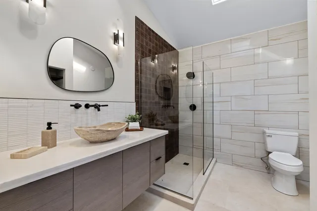 a bathroom with a toilet sink and shower