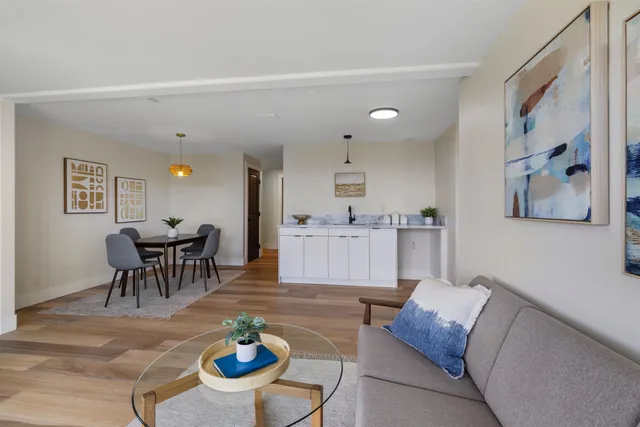 a living room with furniture and a dining table