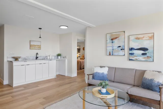 a living room with furniture and a wooden floor