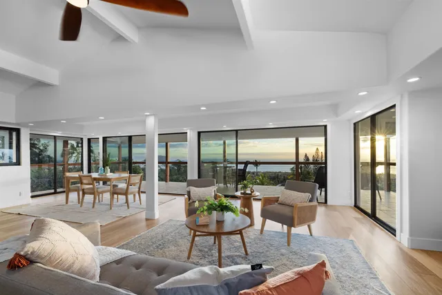 a living room with furniture and large windows