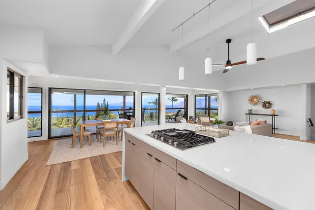 a kitchen with a stove a refrigerator a dining table and chairs with wooden floor