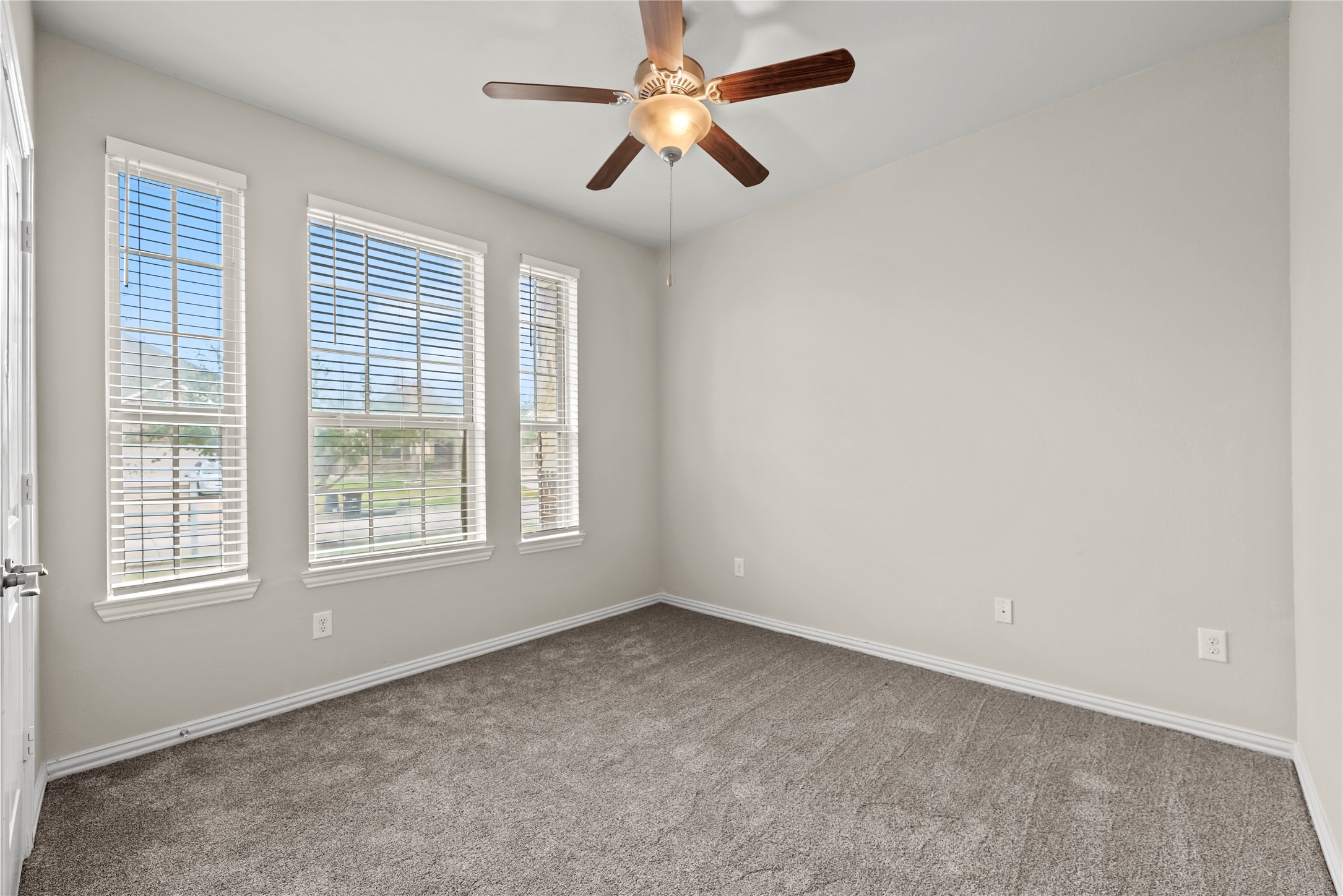 5205 Rainy Garden Court Rosharon, TX 77583 - Photo 21 of 43 an empty room with windows and fan