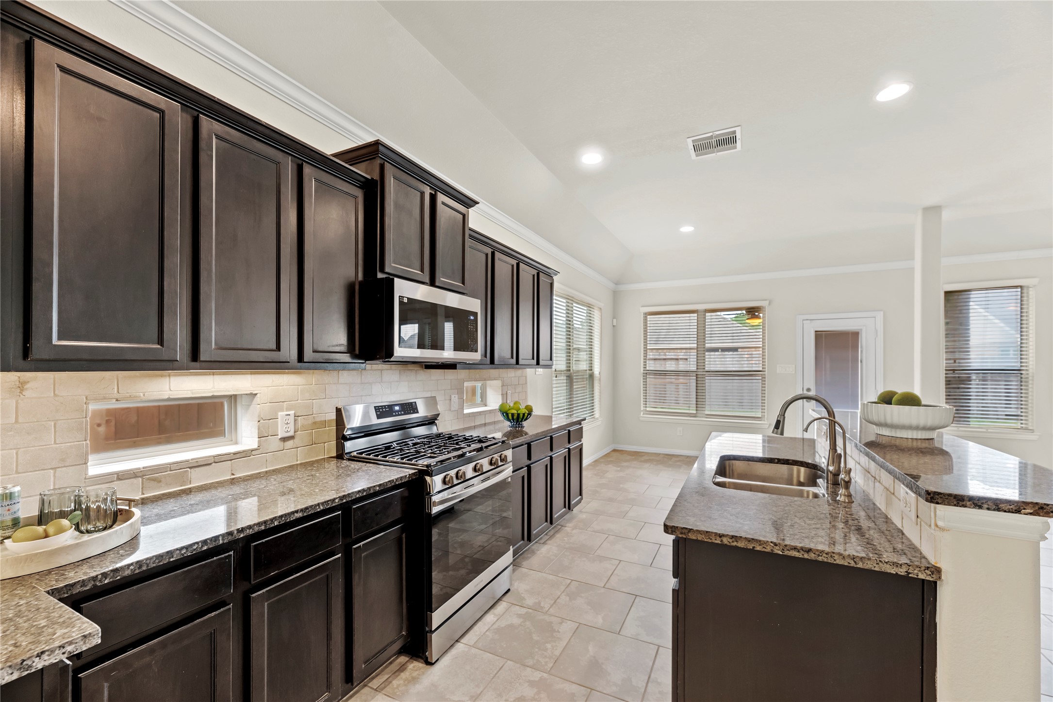 5205 Rainy Garden Court Rosharon, TX 77583 - Photo 3 of 43 a kitchen with stainless steel appliances granite countertop a sink stove and cabinets