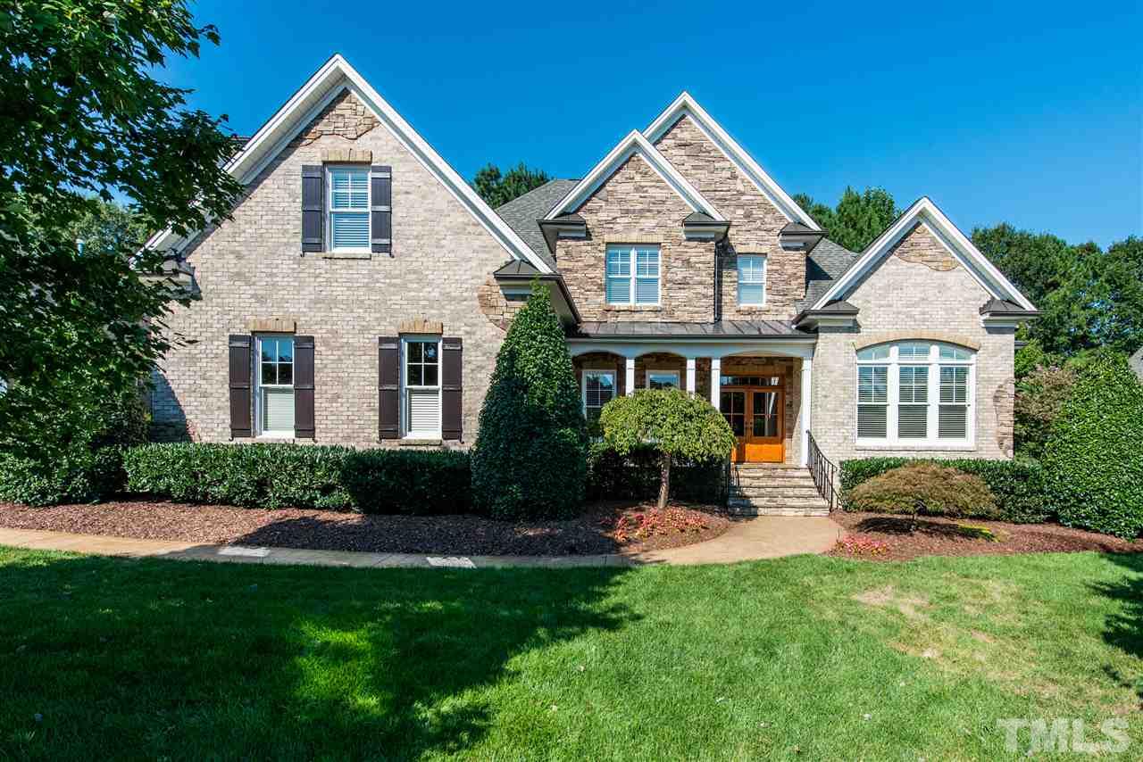 3003 Greyhawk Place Apex, NC 27539 - Photo 1 of 25 a front view of a house with a yard and green space