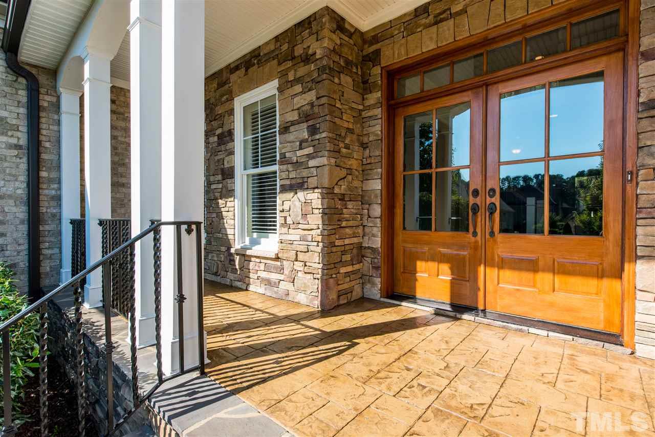 3003 Greyhawk Place Apex, NC 27539 - Photo 2 of 25 a view of a brick house with a large windows