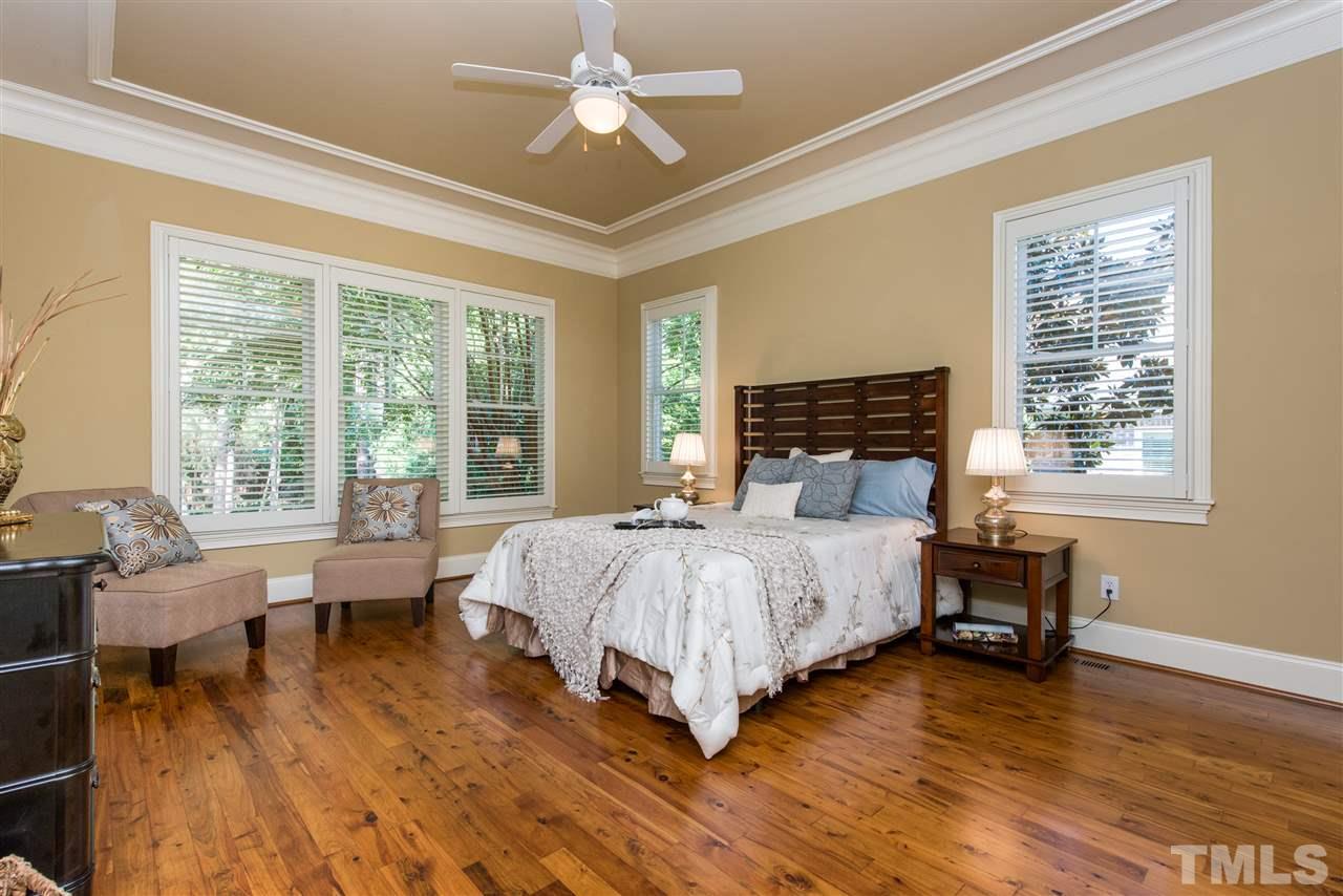 3003 Greyhawk Place Apex, NC 27539 - Photo 12 of 25 a bed room with a bed and a chair