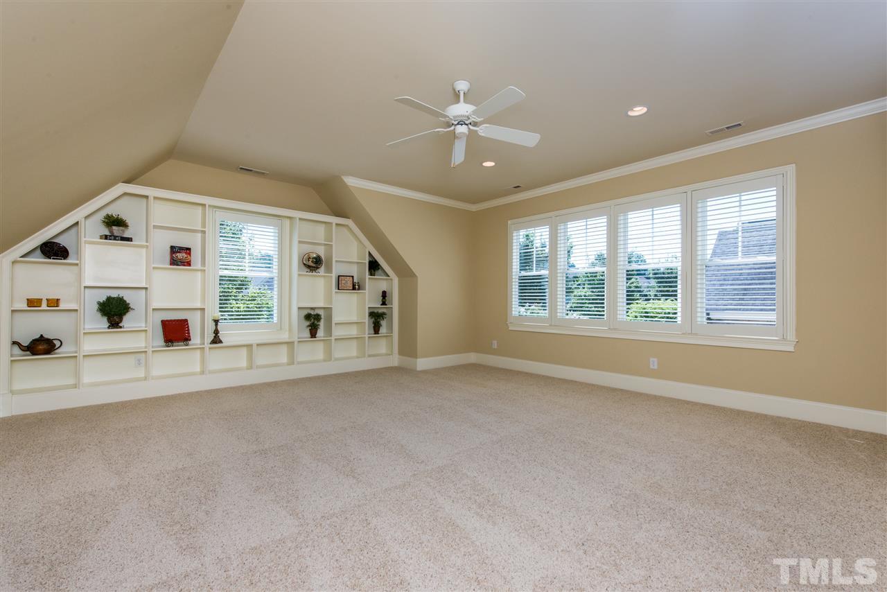 3003 Greyhawk Place Apex, NC 27539 - Photo 18 of 25 an empty room with windows and ceiling fan