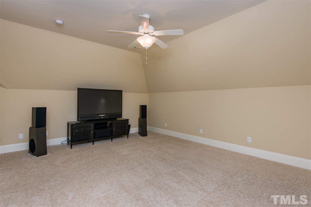 3003 Greyhawk Place Apex, NC 27539 - Photo 19 of 25 en living room with furniture and a flat screen tv