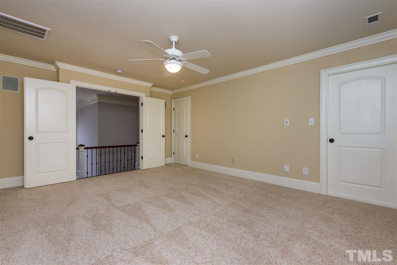 3003 Greyhawk Place Apex, NC 27539 - Photo 20 of 25 a view of an empty room with a ceiling fan