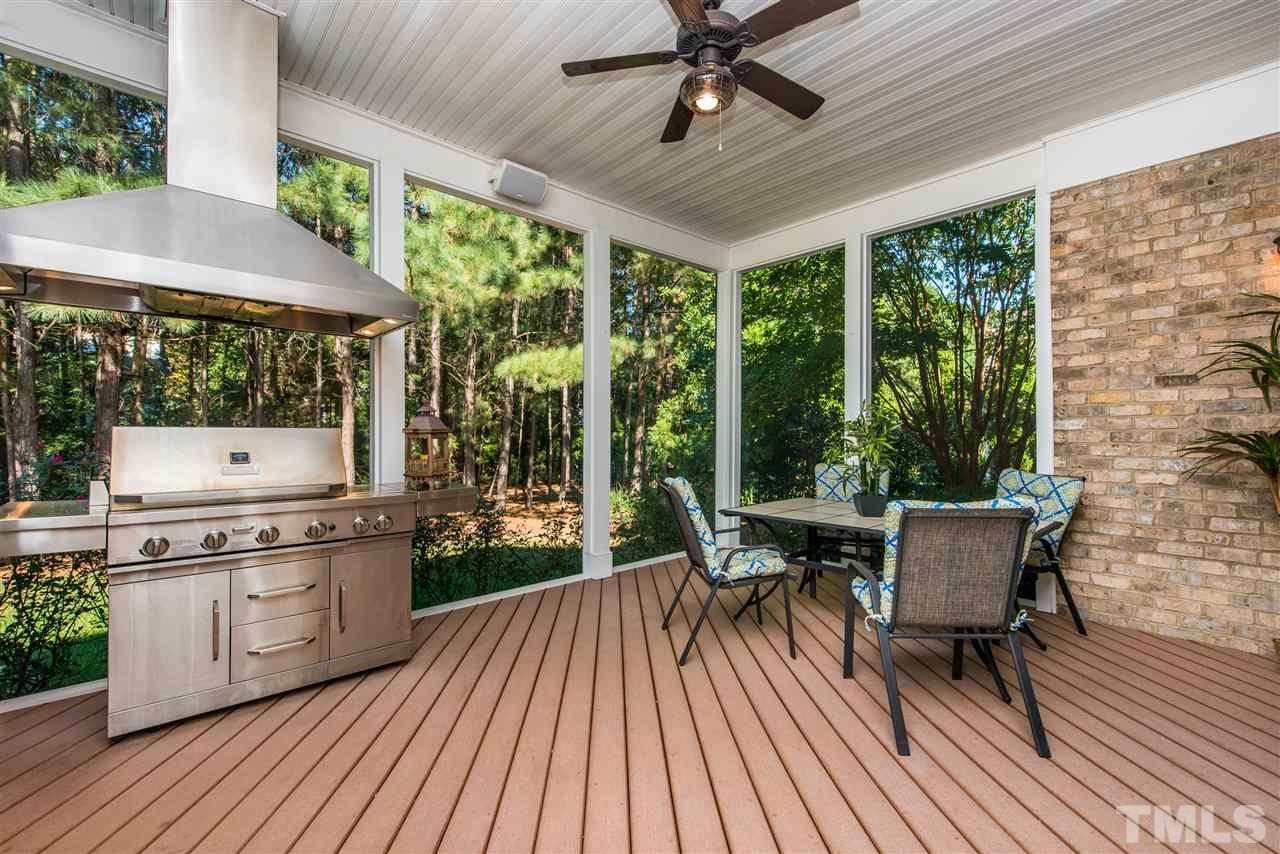 3003 Greyhawk Place Apex, NC 27539 - Photo 21 of 25 a view of a patio with table and chairs and wooden floor