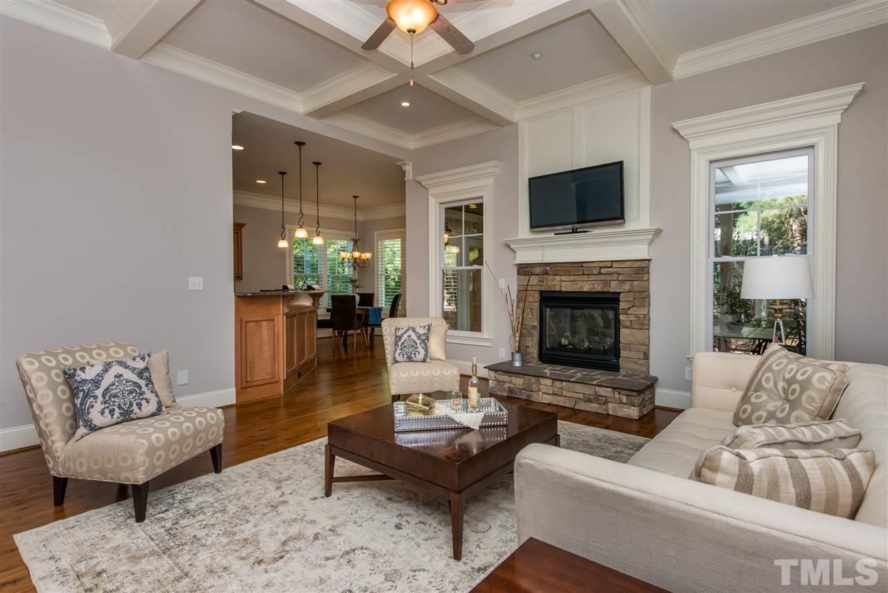 3003 Greyhawk Place Apex, NC 27539 - Photo 10 of 25 a living room with furniture flat screen tv and a fireplace