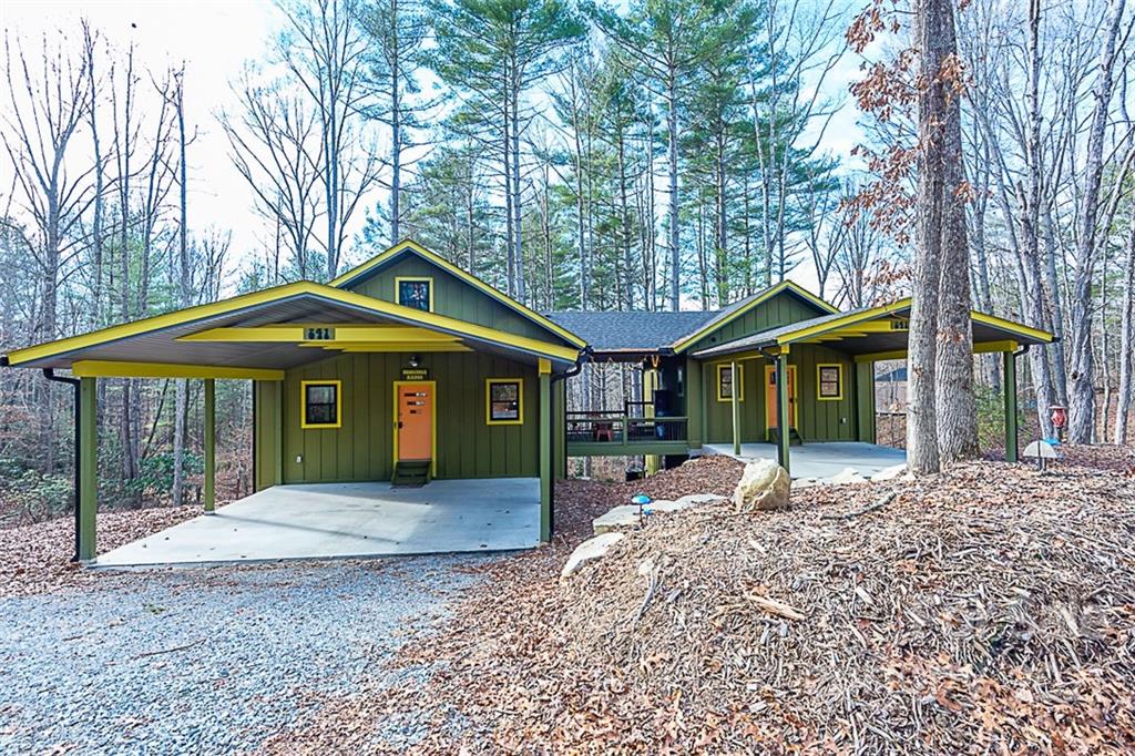 a front view of a house with a yard and outdoor seating