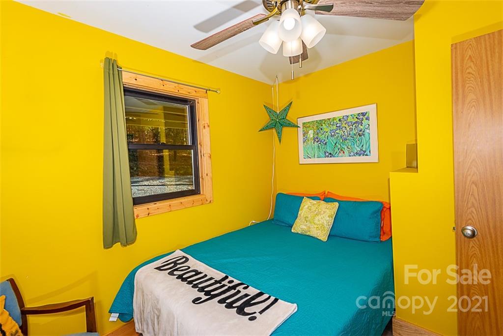 241 Ray Hill Road Horse Shoe, NC 28742 - Photo 18 of 43 a bedroom with a bed and a window