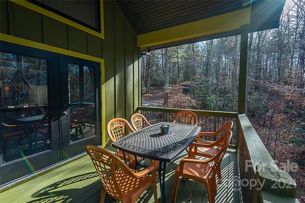 241 Ray Hill Road Horse Shoe, NC 28742 - Photo 24 of 43 a view of balcony with a table and chairs