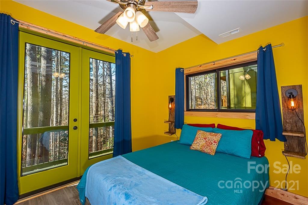 241 Ray Hill Road Horse Shoe, NC 28742 - Photo 27 of 43 a bedroom with a bed and wooden floor