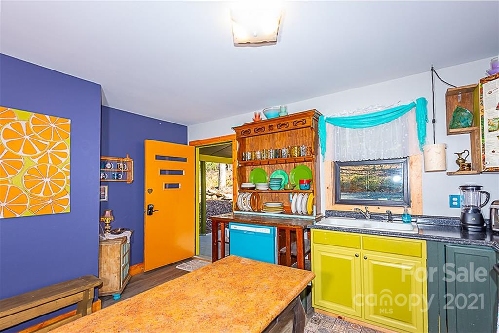 241 Ray Hill Road Horse Shoe, NC 28742 - Photo 8 of 43 a room with a table chairs and a kitchen view