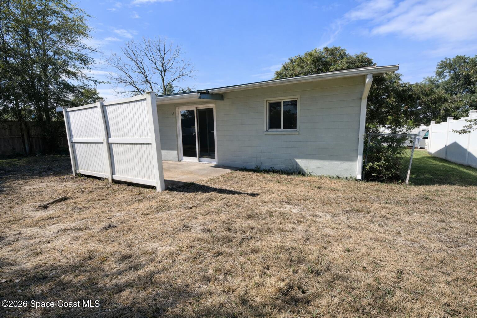 1336 Estridge Drive Rockledge, FL 32955 - Photo 11 of 11 a backyard of a house with garage