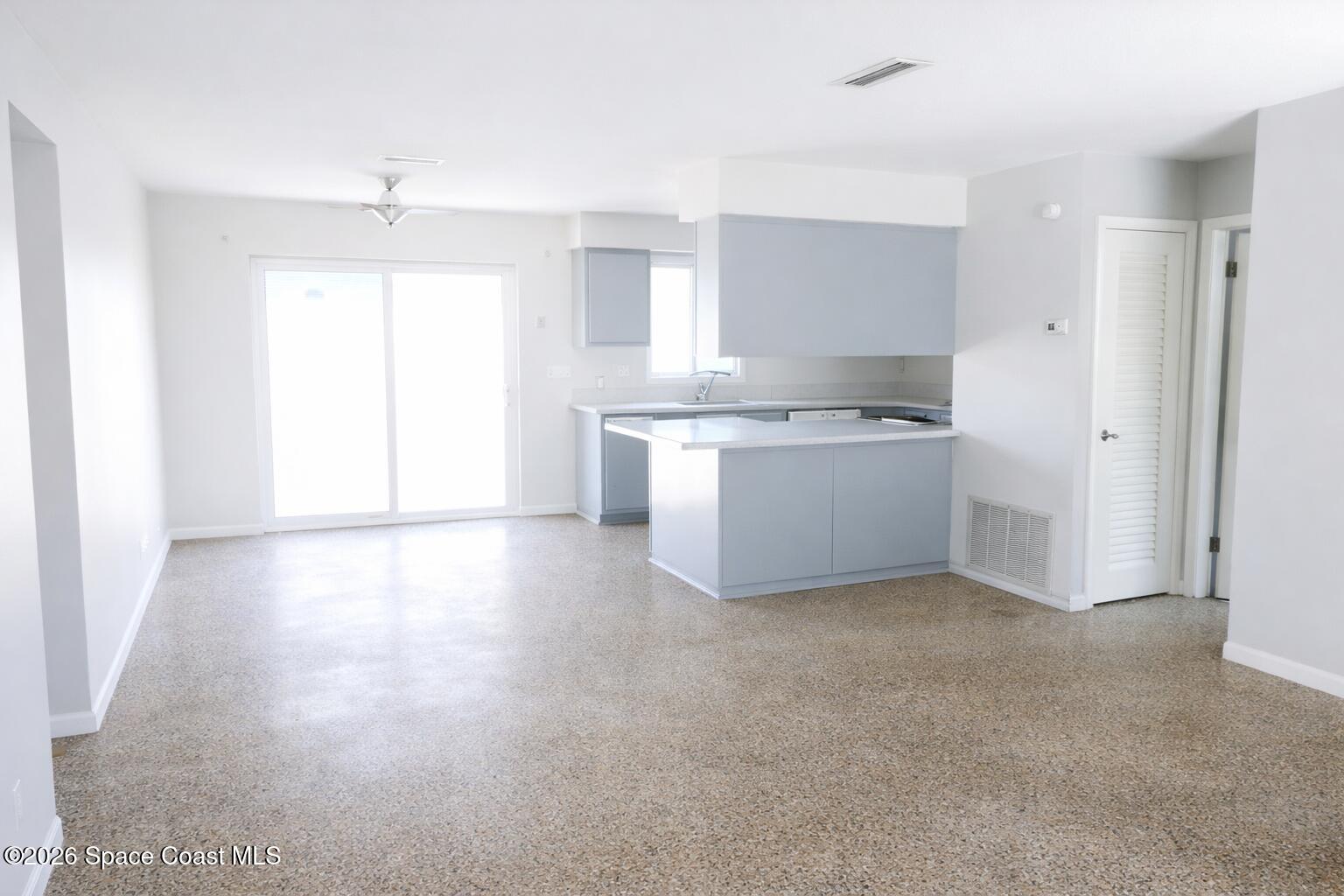 1336 Estridge Drive Rockledge, FL 32955 - Photo 3 of 11 a kitchen with a stove a sink and a refrigerator