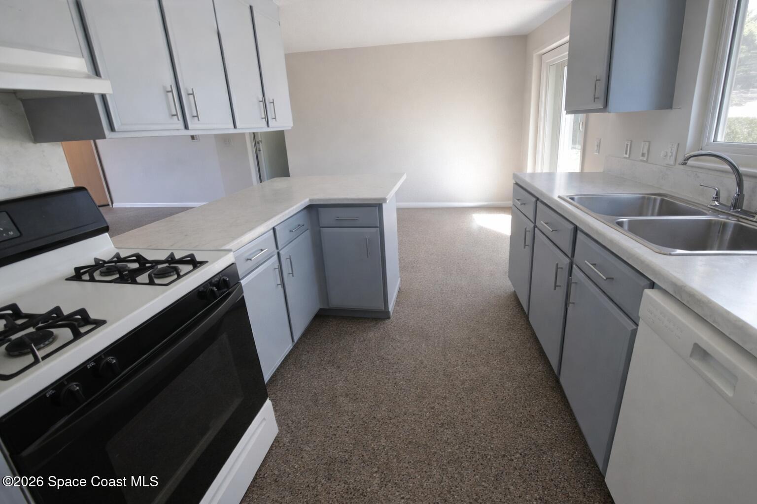 1336 Estridge Drive Rockledge, FL 32955 - Photo 4 of 11 a kitchen with a stove and a sink