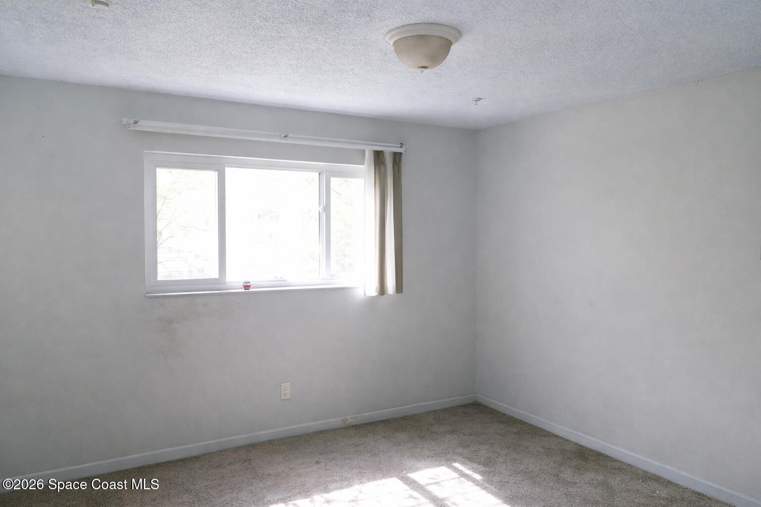 1336 Estridge Drive Rockledge, FL 32955 - Photo 9 of 11 an empty room with a window