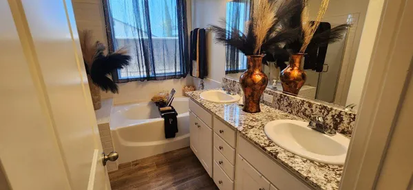 a dining room with furniture and wooden floor