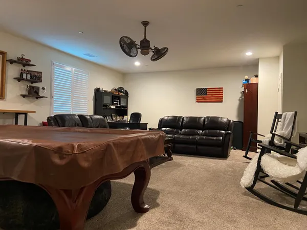 a living room with dining table and a flat screen tv