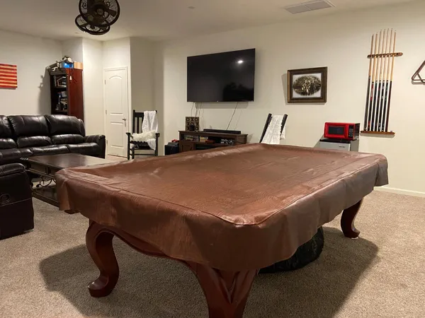 a bathroom with a granite countertop sink a toilet and a mirror