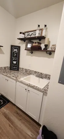 a view of a hallway with wooden floor and closet