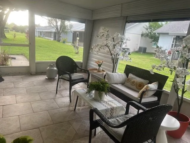 a living room with furniture and a floor to ceiling window