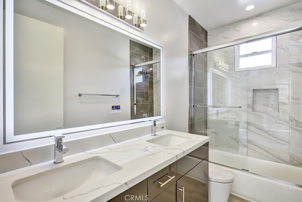 1908 Perry Avenue, Unit B Redondo Beach, CA 90278 - Photo 11 of 20 a bathroom with a granite countertop sink a toilet a mirror and shower