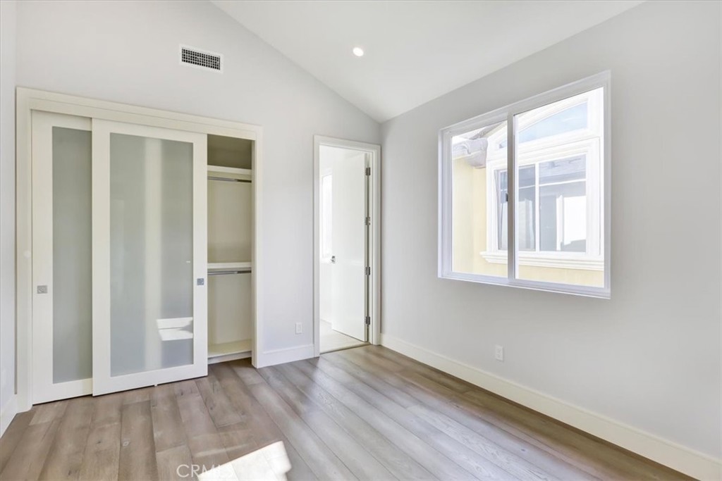 1908 Perry Avenue, Unit B Redondo Beach, CA 90278 - Photo 12 of 20 an empty room with wooden floor and windows