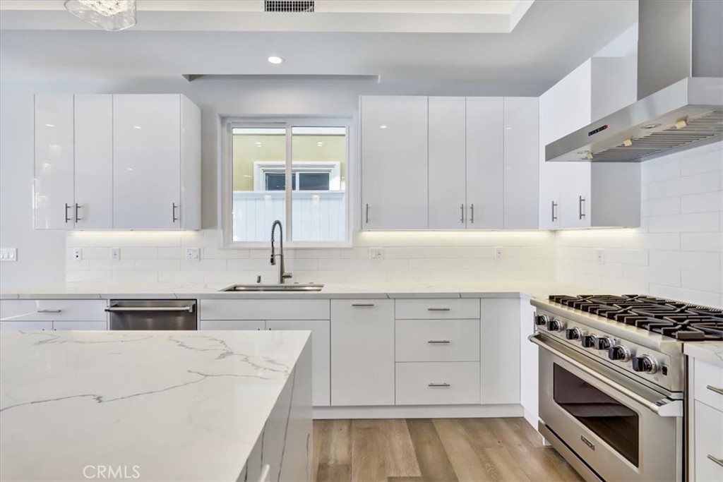 1908 Perry Avenue, Unit B Redondo Beach, CA 90278 - Photo 5 of 20 a kitchen with granite countertop a stove sink and cabinets