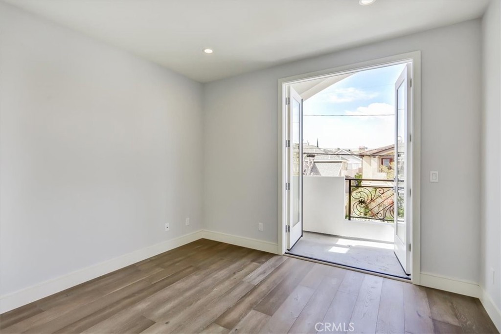 1908 Perry Avenue, Unit B Redondo Beach, CA 90278 - Photo 7 of 20 an empty room with wooden floor and windows